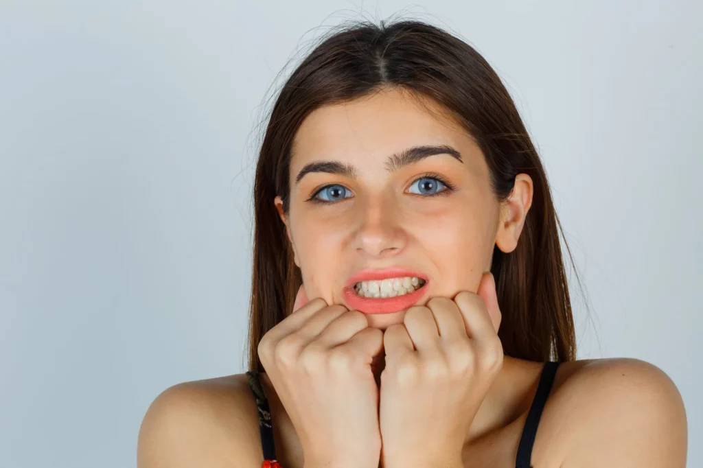 A woman showing her gums with infection